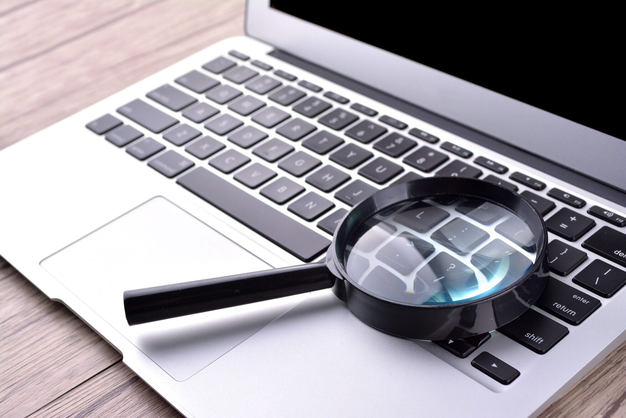 Laptop with magnifying glass